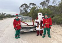 Father Christmas travels in ute
